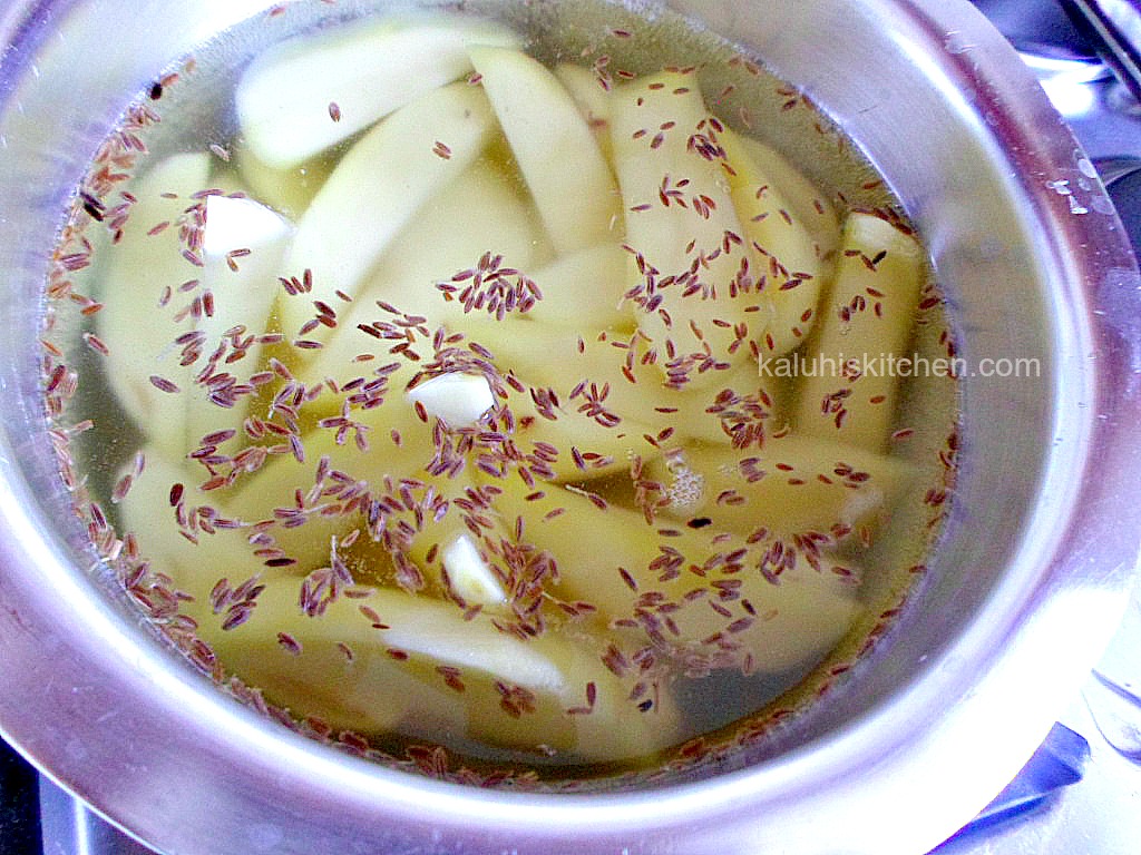 boiling potato wedges with cumin seeds to infuse more flavor