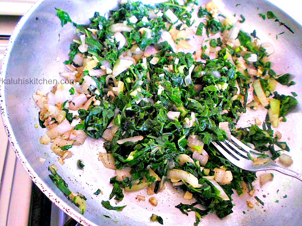 adding spinach to sauteed onions