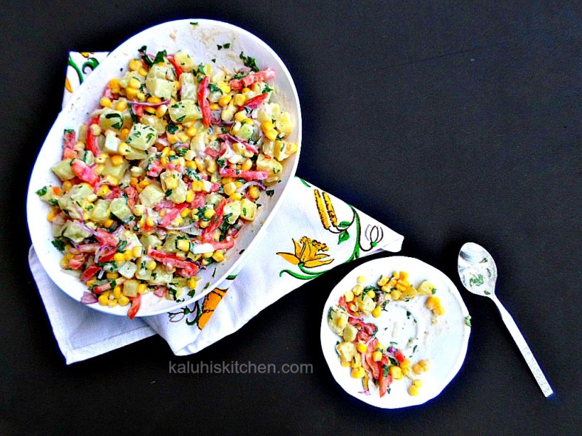 potato salad with tomatoes, sweet corn, red onion, and fresh parsely