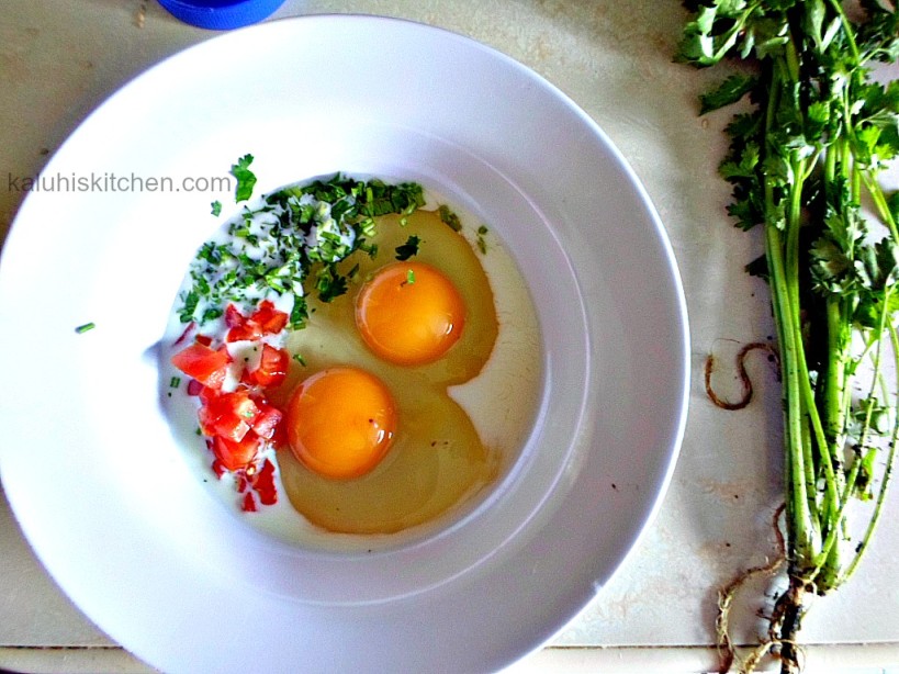 whisking eggs with some tomatoes and fresh coriander for theavocado and sesame seed milky omelette