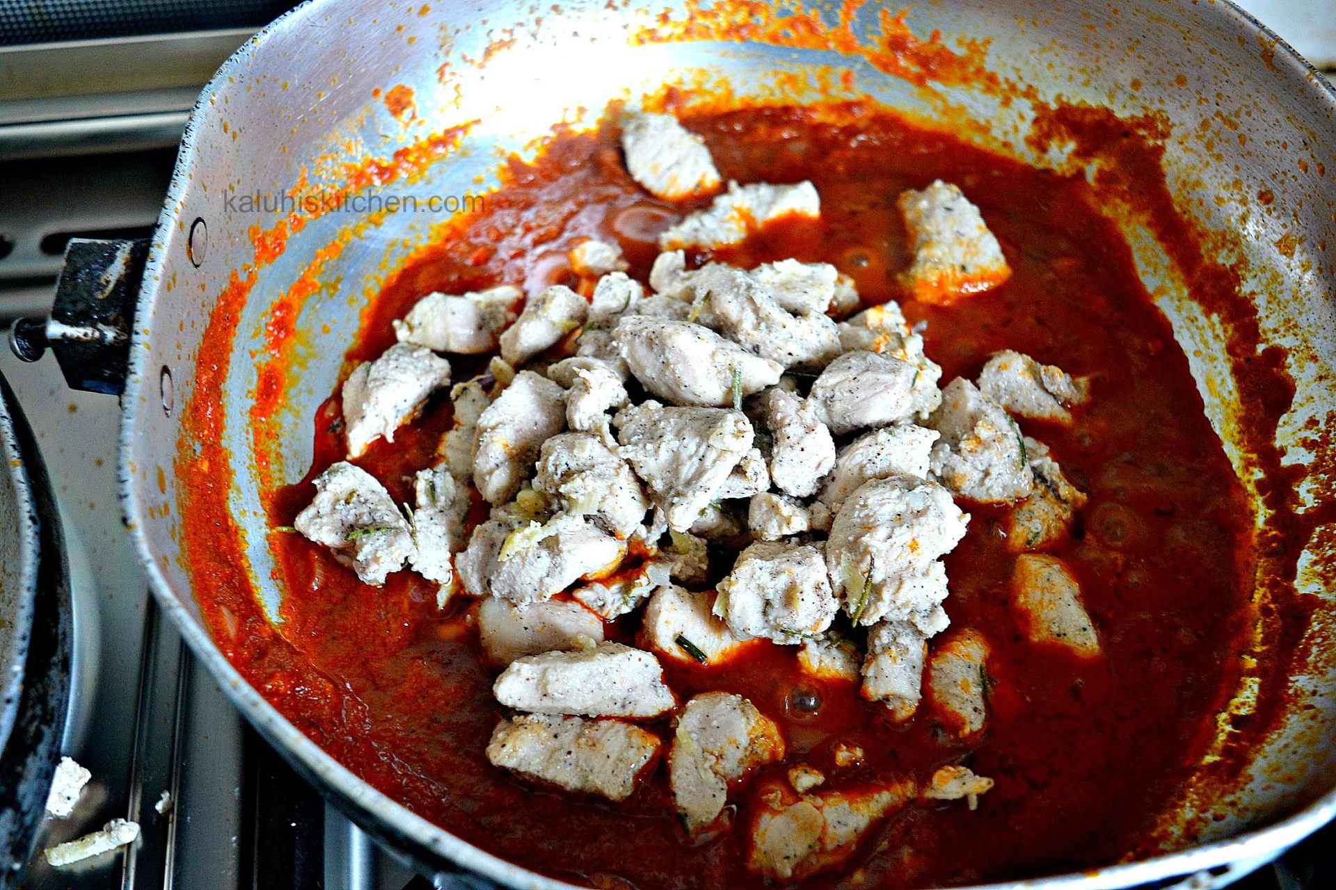 add the chicken to the masala sauce and allow it to simmer so that all the flavors amalgamate_chicken tikka from kaluhiskitchen.com