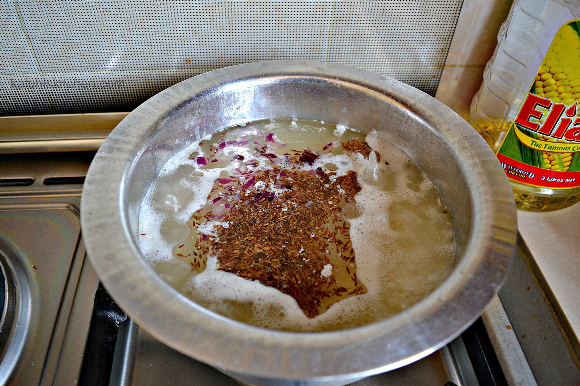 boiling rice with the cumin and red onion tempers the onion taste and softens the cumin_wali wa nazi_kenyan food_kaluhiskitchen.com