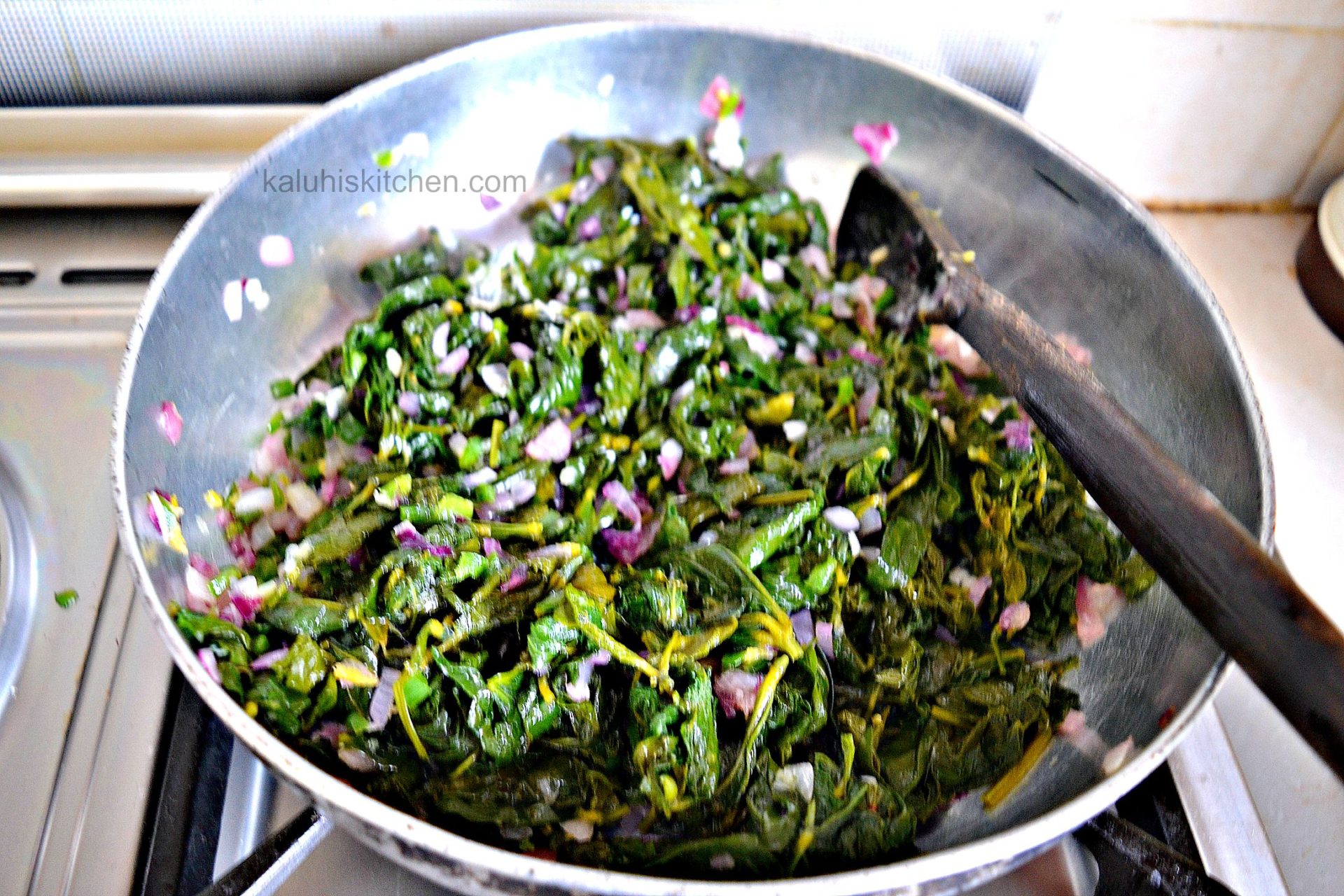 kunde sauteing in red onion and garlic_kenyan food_kunde recipe_kaluhiskitchen.com