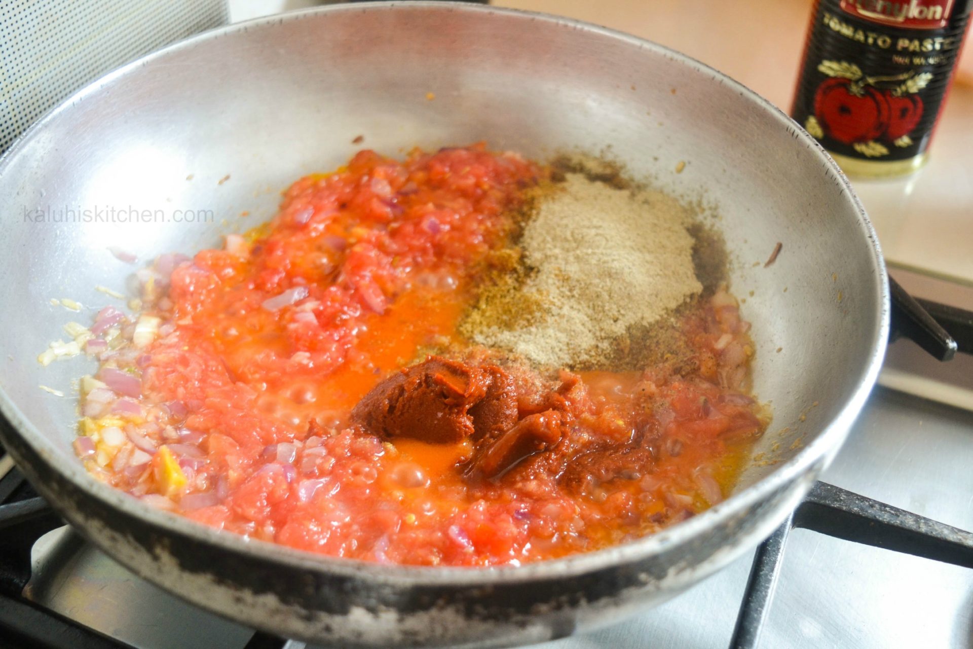 tomato paste simmering with tomatoes thickens the entire mixture and sets the consistency of the entire dish_kaluhiskitchen.com