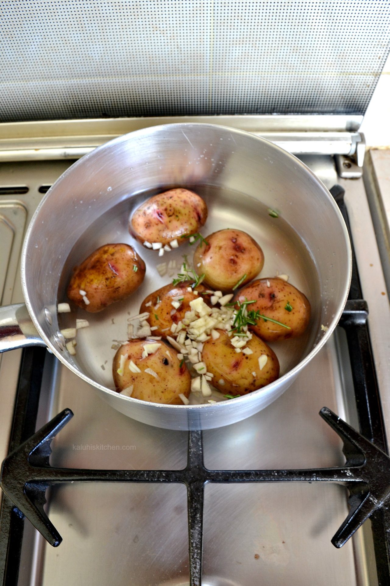 boiling potatoes with garlic and rosemary makes them alot more tasty and tasty_kaluhiskitchecn.com