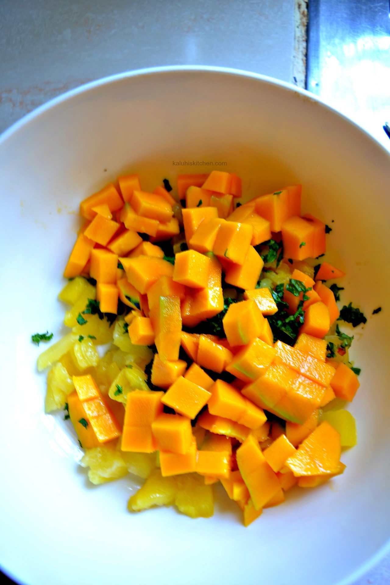 ad the mango nad mix it in with the pineapple and mint and allow it to sit for a while_mango mint salad_how to make mango mint salad