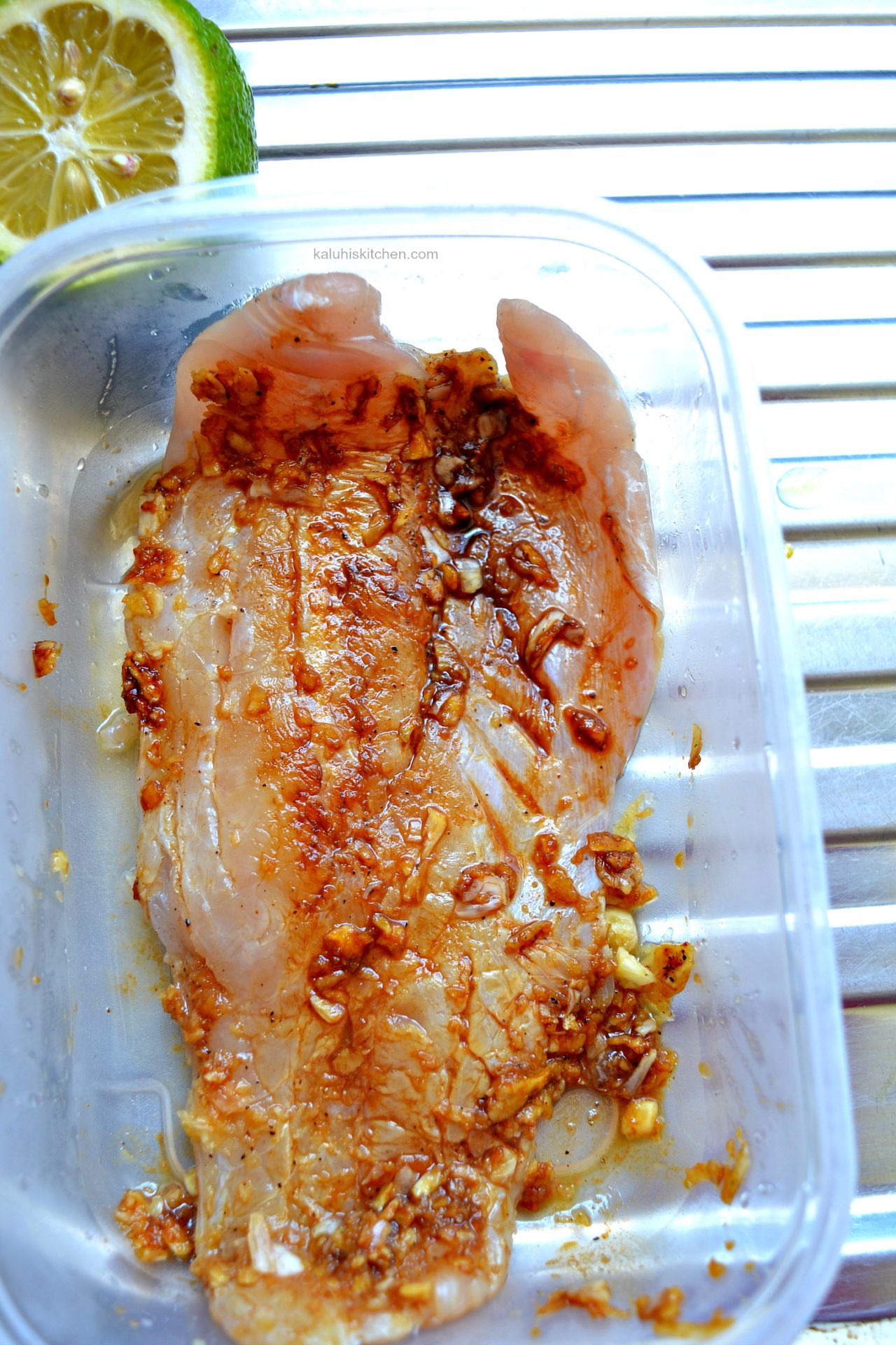 marinating fish in plenty of garlic brings out its flavor together with soy sauce and salt_how to make fish masala_kaluhiskitchen.com