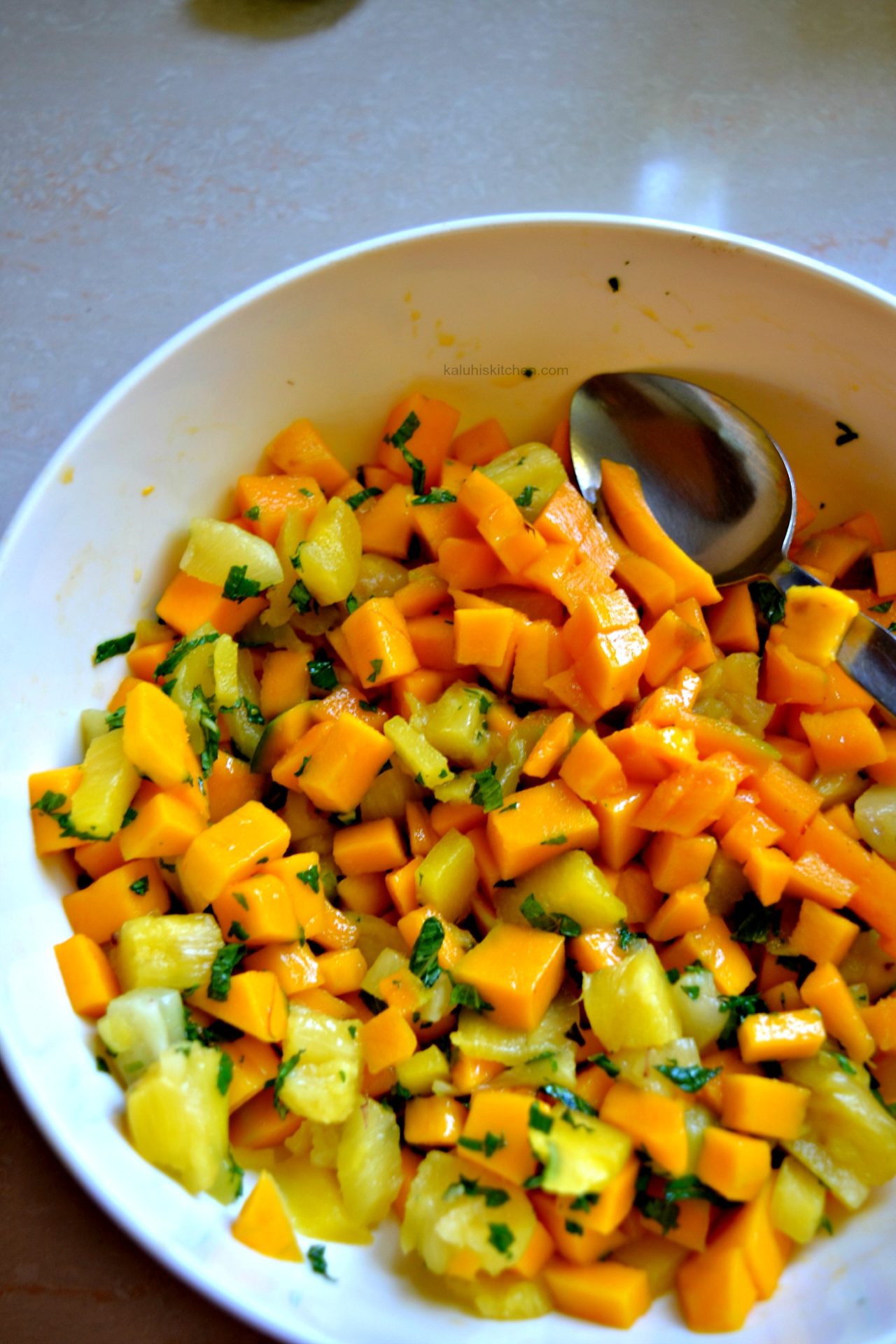 mix all the fruits of your mango mint salad together amd allow it to rest for a few minutes so that all the flavors mix in_kaluhiskitchen.ocm