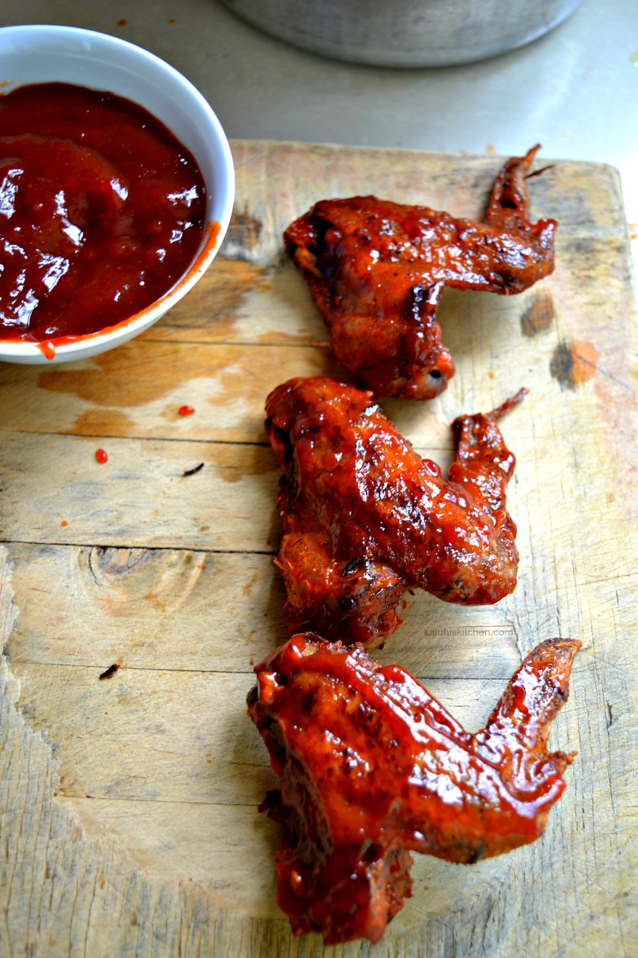 slather the sauce on your marinated and seasoned chicken wings_kaluhiskitchen.com