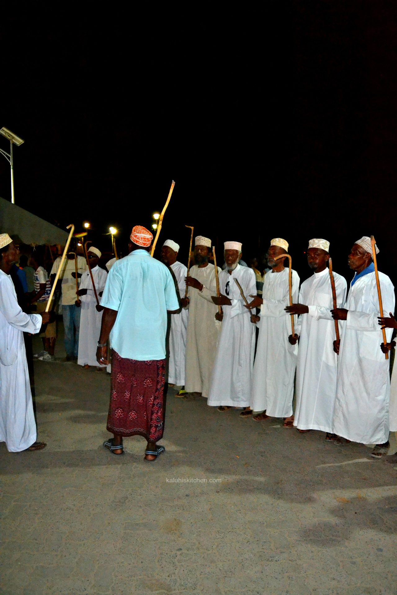 LOCAL RESIDENTS, MOSTLY MEN, LINE UP THE LAMU SEA FRONT AND SING SONGS THAT speak of teh heritage of lamu county_kaluhiskitchen.com