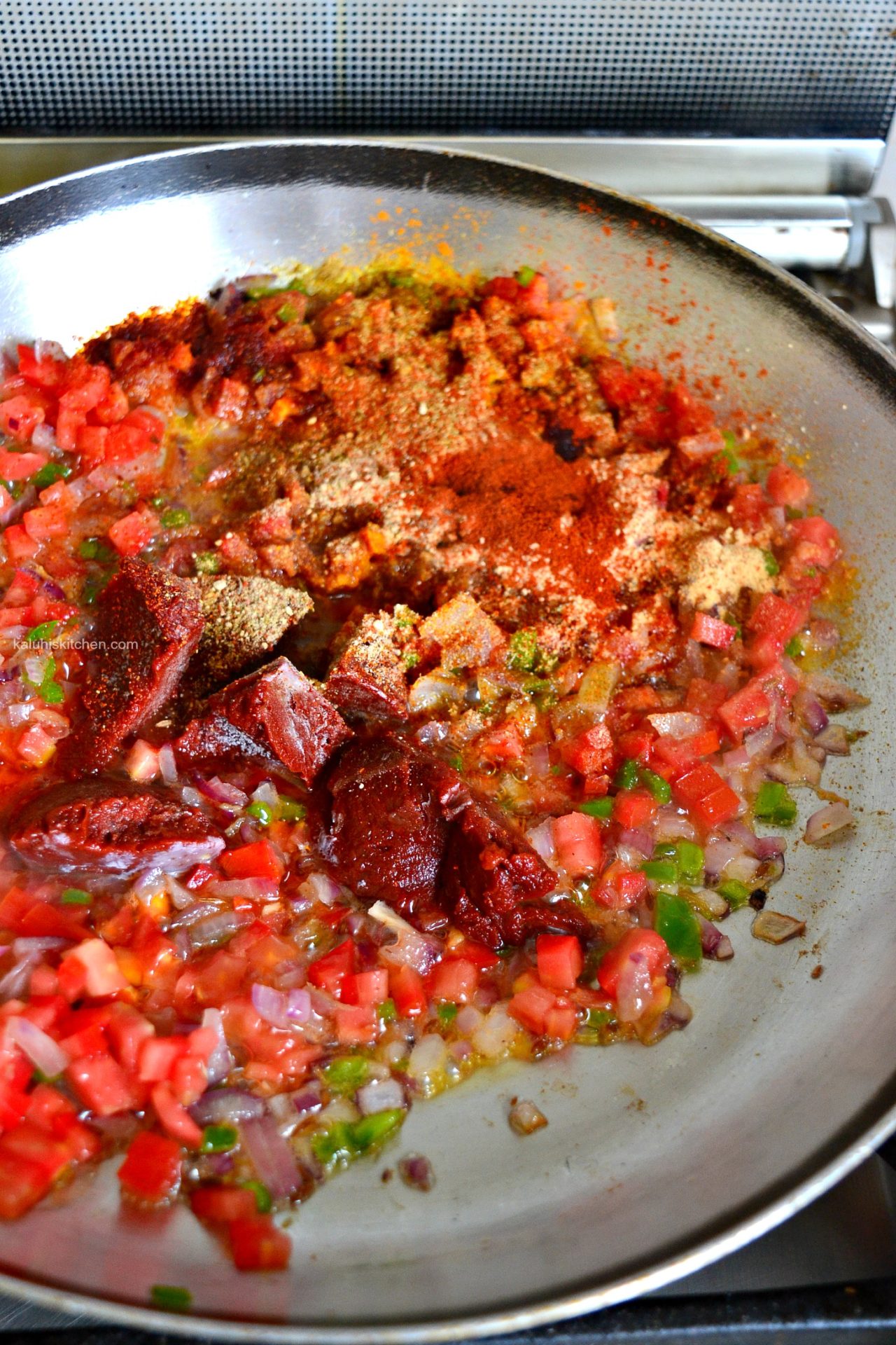 add the tomato paste tomatoes and all the spices for the masala and allow this to cook down for about 15 minutes_ginger matoke masala_kaluhiskitchen.com
