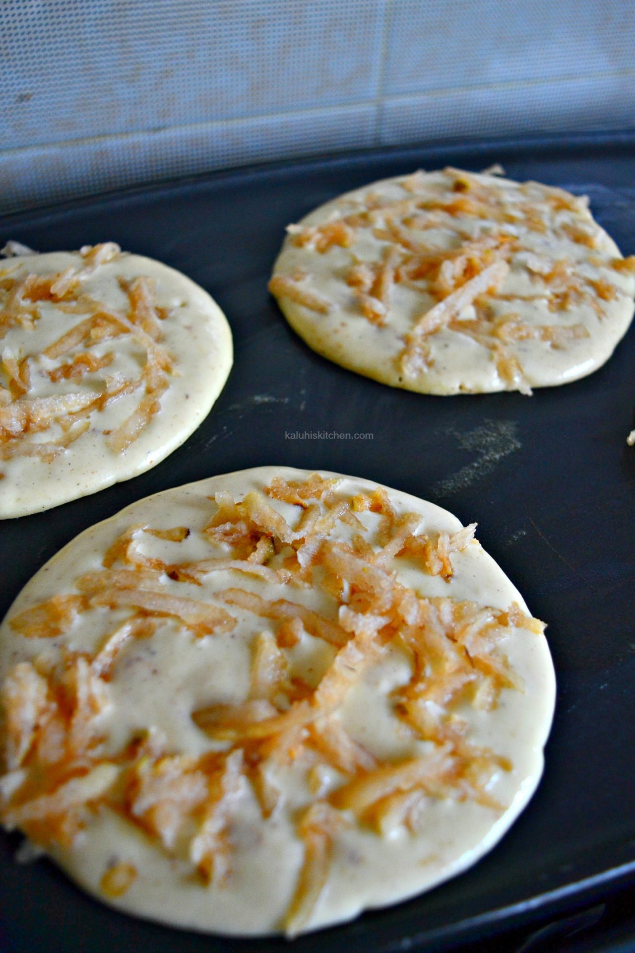 add your grated pear on the surface of the pancake before it sets and this will allow it to stick and cook with them_kaluhiskitchen.com