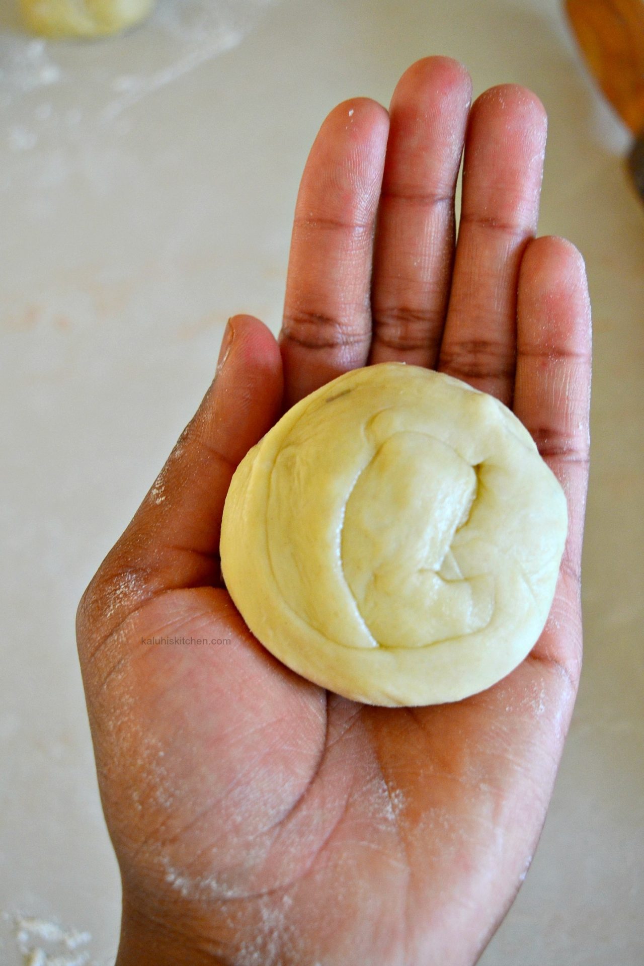 the layers in the rolled in the chapari bun are the ones that will form the layers of the chapati_how to roll chapati_chapati dough_kaluhiskitchen.com