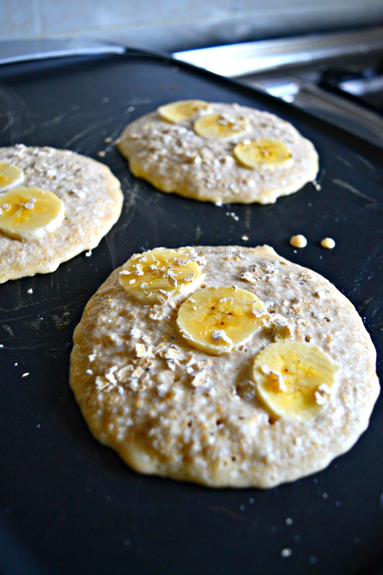 add the bananas on the unset side of the oat pancakes together with some raw oats just for texture_kaluhiskitchen.com
