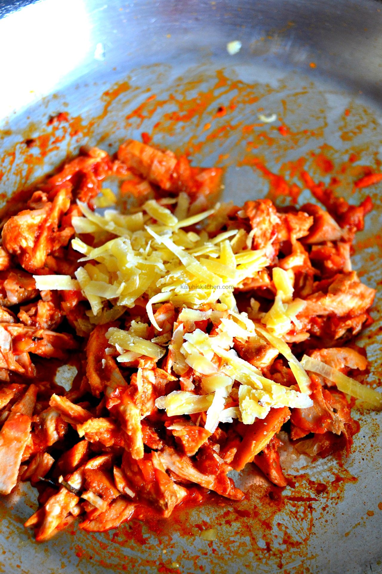 add cheese while the chicken is cooking down so that it melts witht he hot chicken and adds more depth and flavor_kaluhiskitchne.com