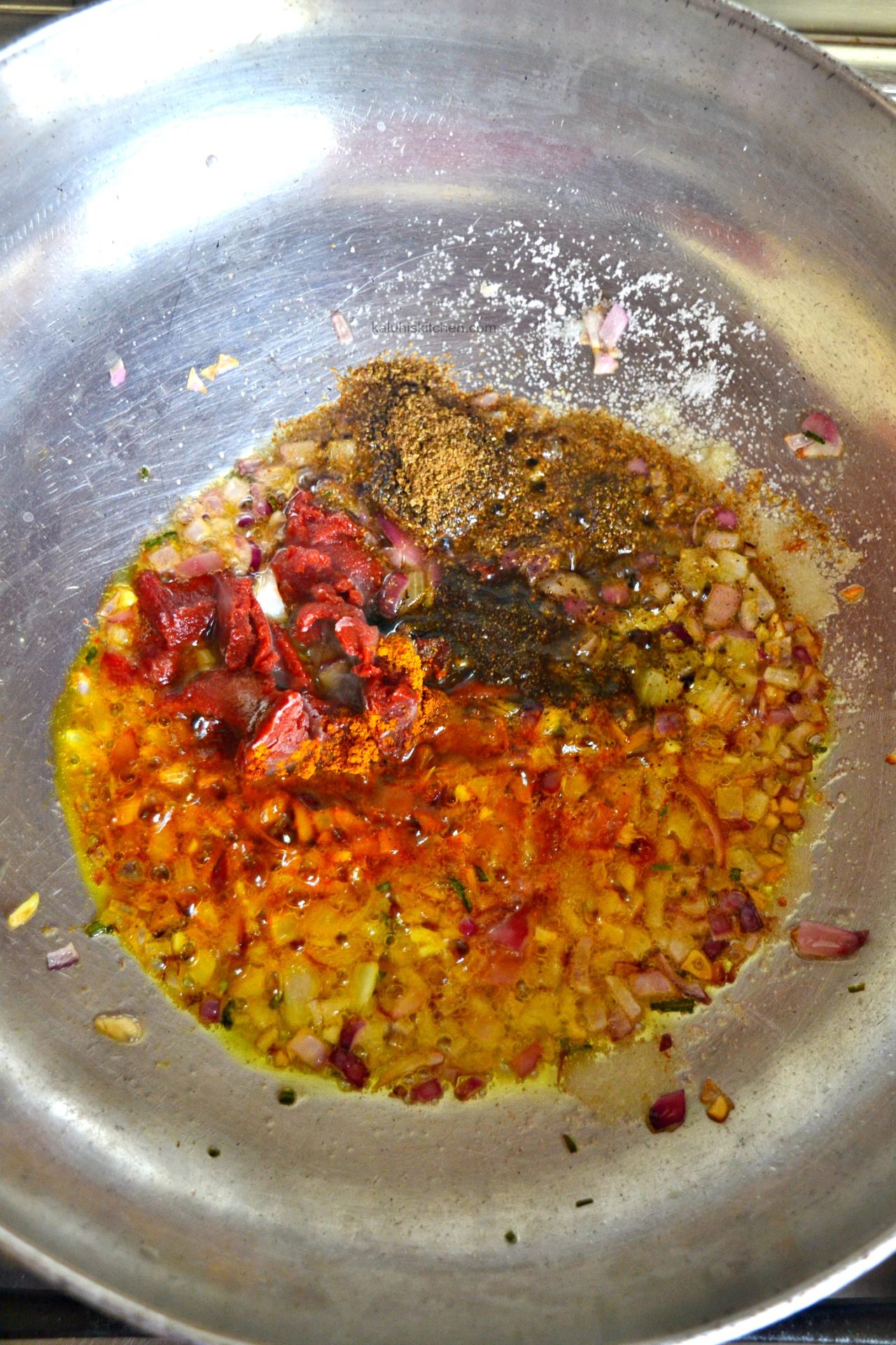 add the spices and the tomato paste together with some water and allow them to cook down for some minutes so that all the spices meld_kaluhiskitchen.com