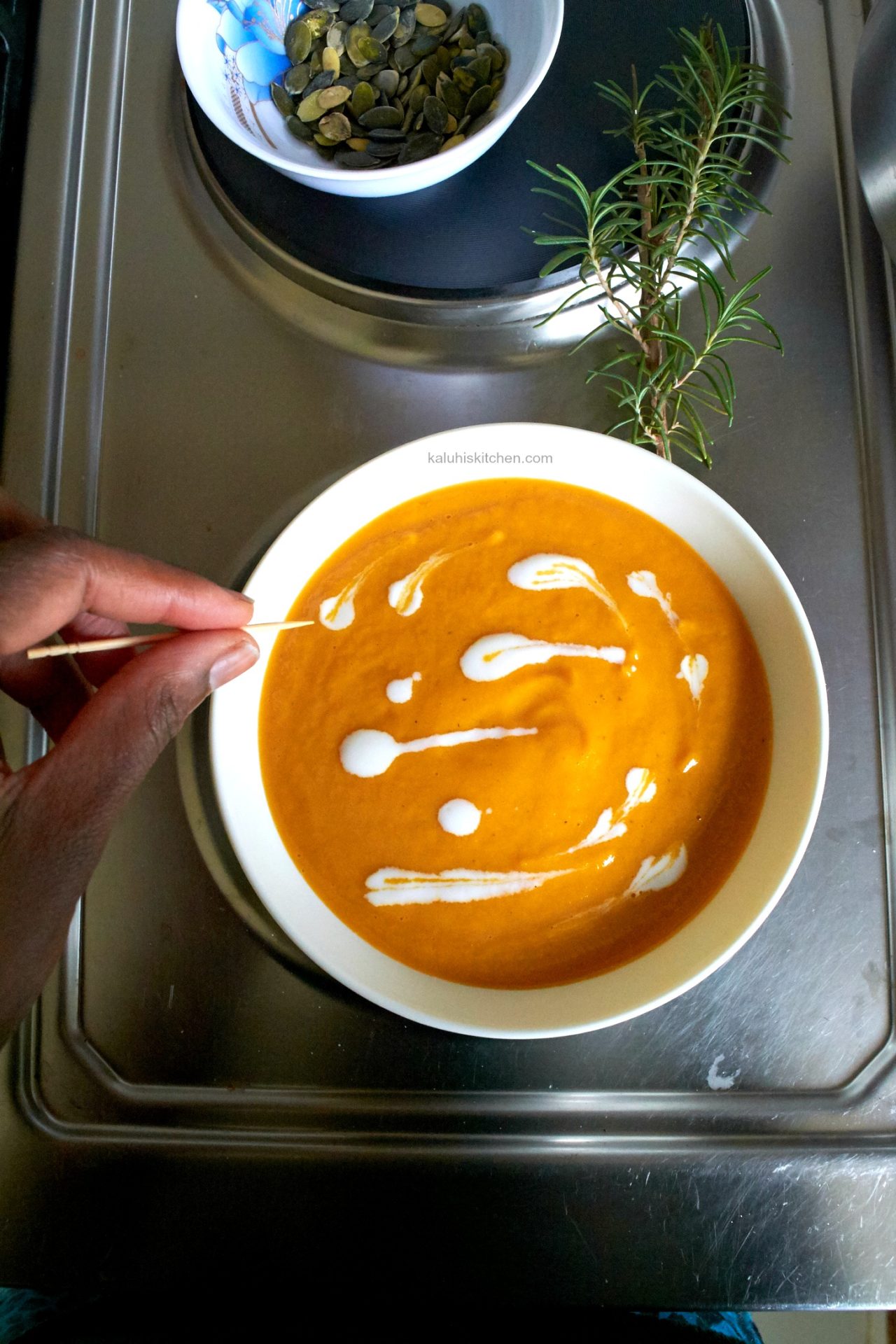 garnish your soup with heavy cream_kaluhiskitchen.com_carrot soup_karafuu and rosemary carrot soup