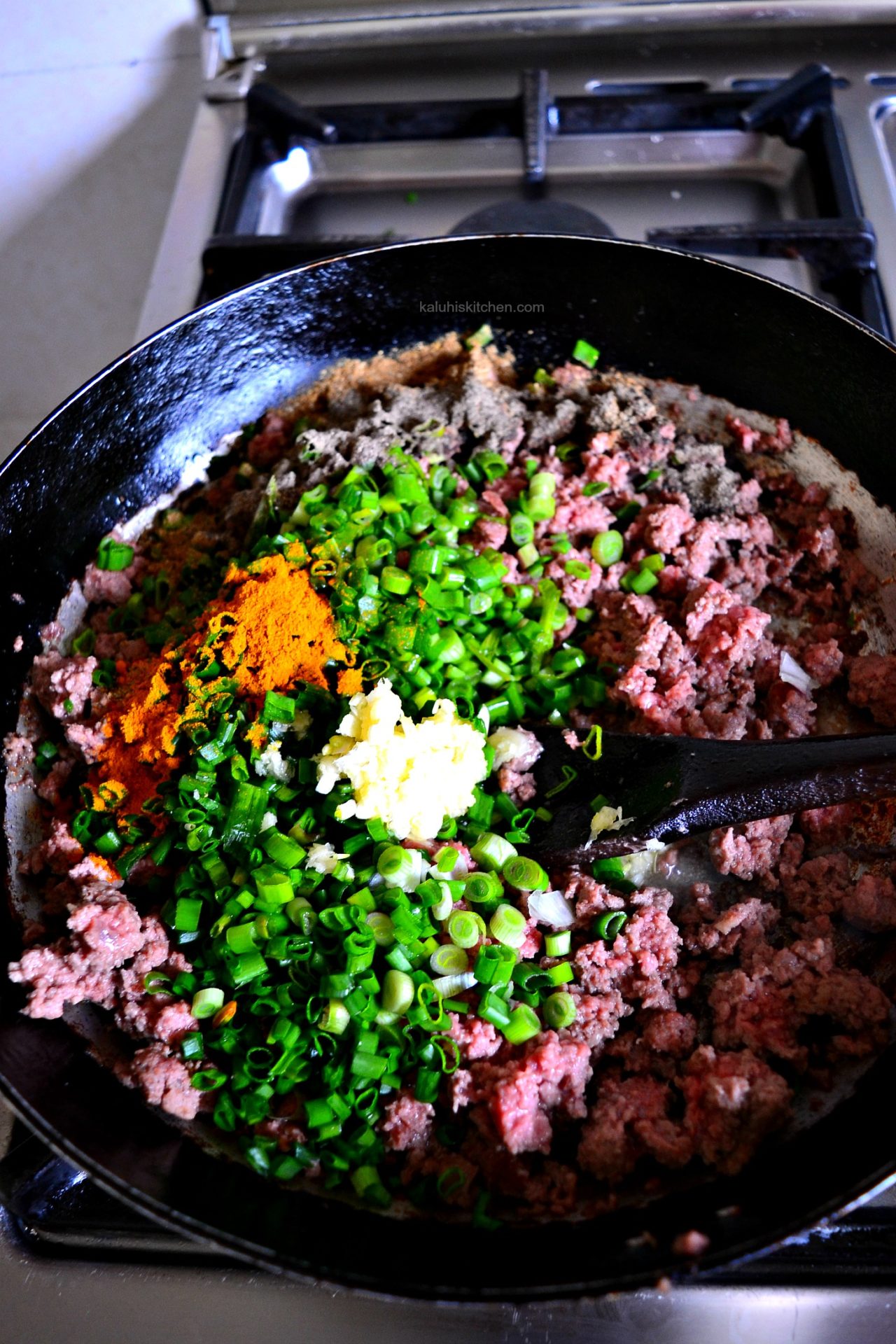 adding some spring onion and turmeric to the almost cooked minced beef adds plenty of flavor to the samosa filling_how to make samosas_kaluhiskitchen.com