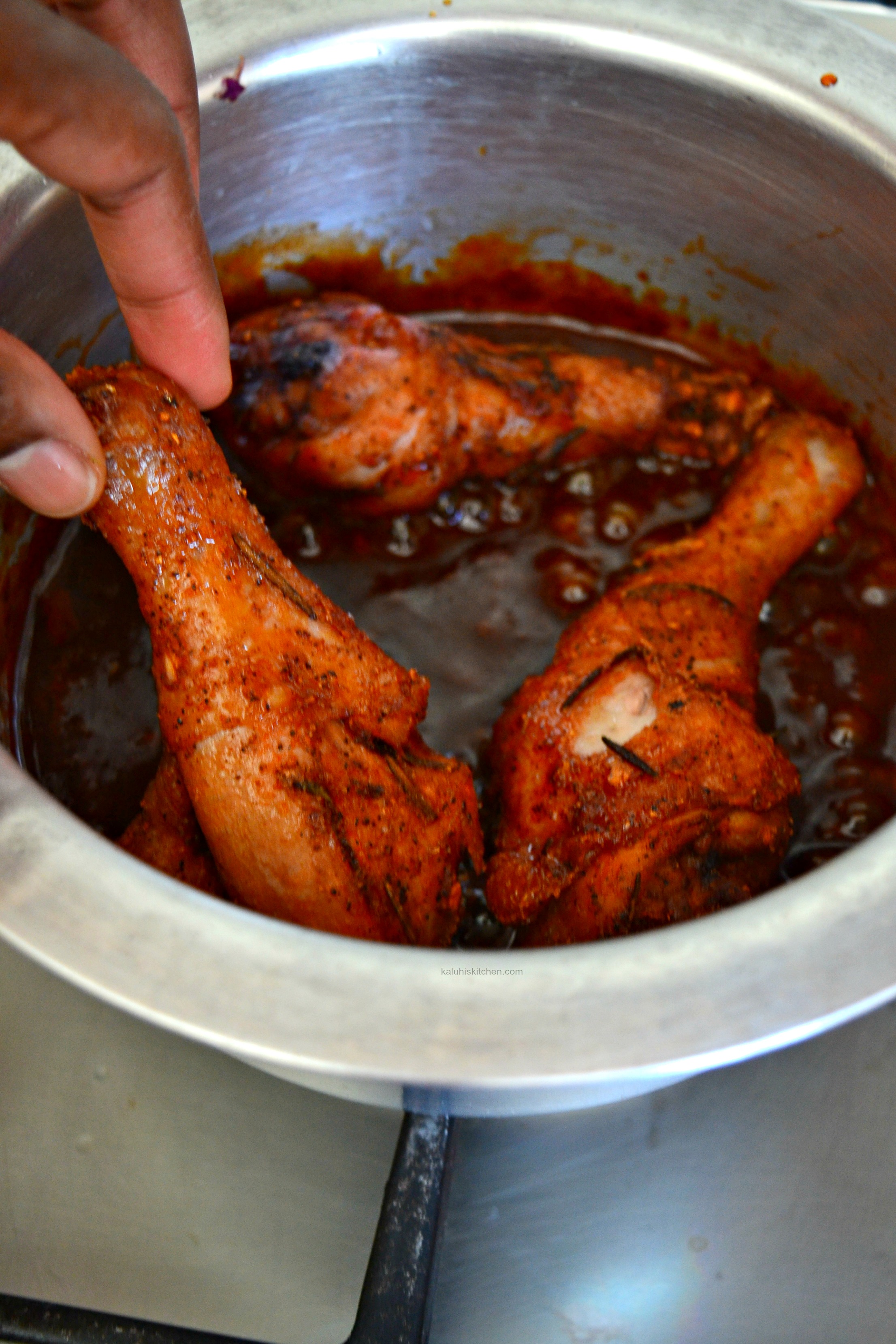 after-the-drumsticks-are-fried-place-them-in-the-simmered-down-sauce-and-allow-them-to-cook-for-a-few-minutes-in-the-sauce_kaluhiskitchen-com