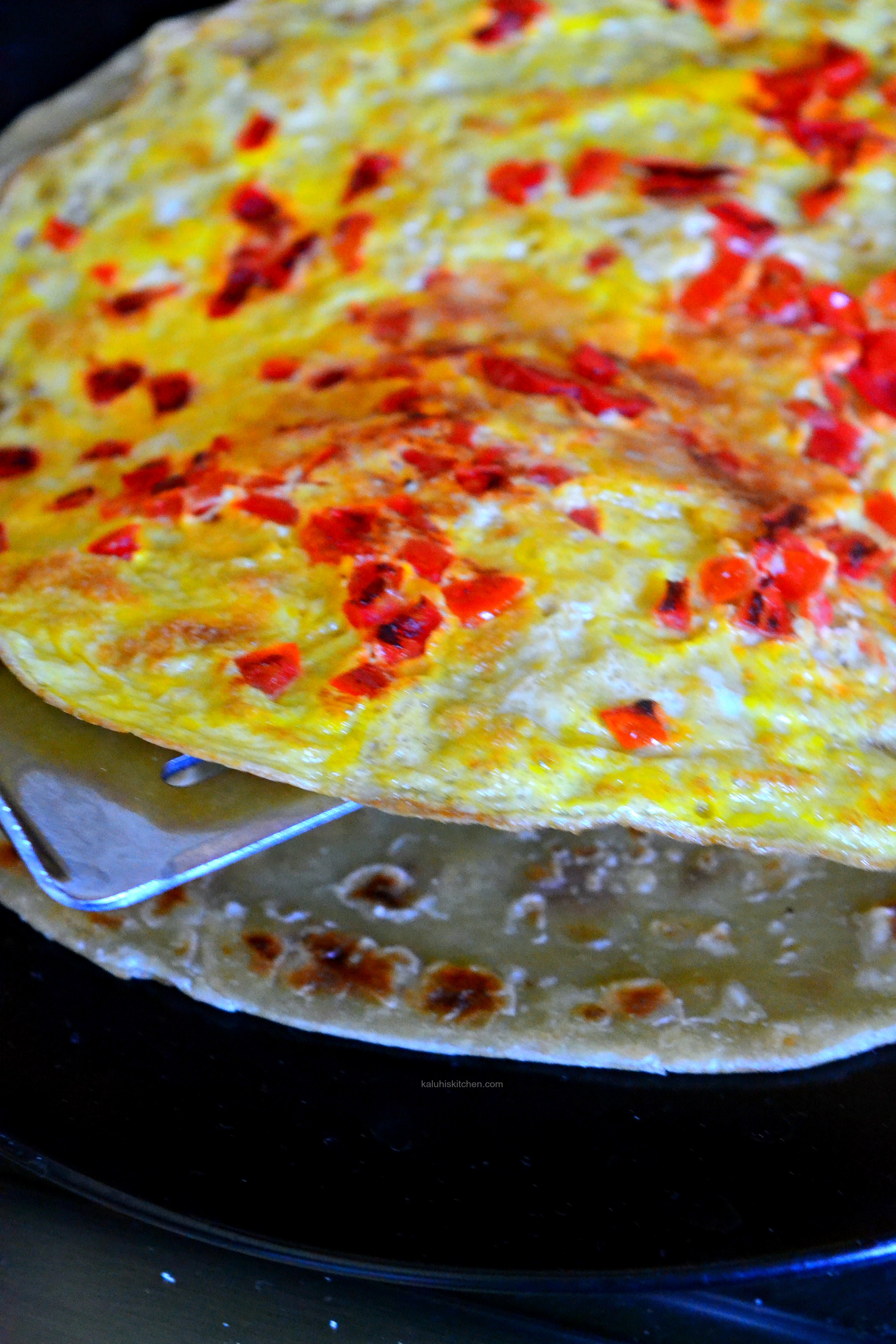 the-first-layer-is-the-omelette-palce-it-over-the-chapati_sweet-chili-mbuzi-choma-rolex_kaluhiskitchen-com